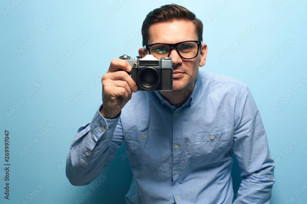 Young male photographer holding a new camera Young male photographer holding a new camera