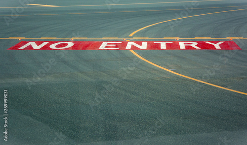 No entry sign at the runway of the airport on asphalt