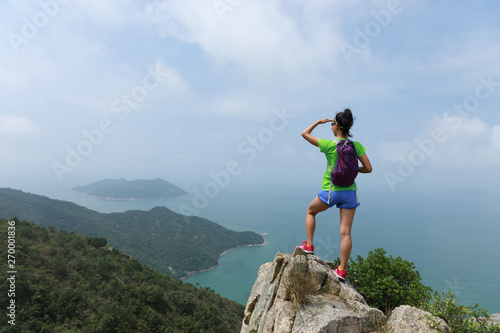 Successful Woman Hiker enjoy the beautiful view In Seaside Mountain Top
