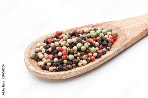 Pepper mix seed on spoon on white background.