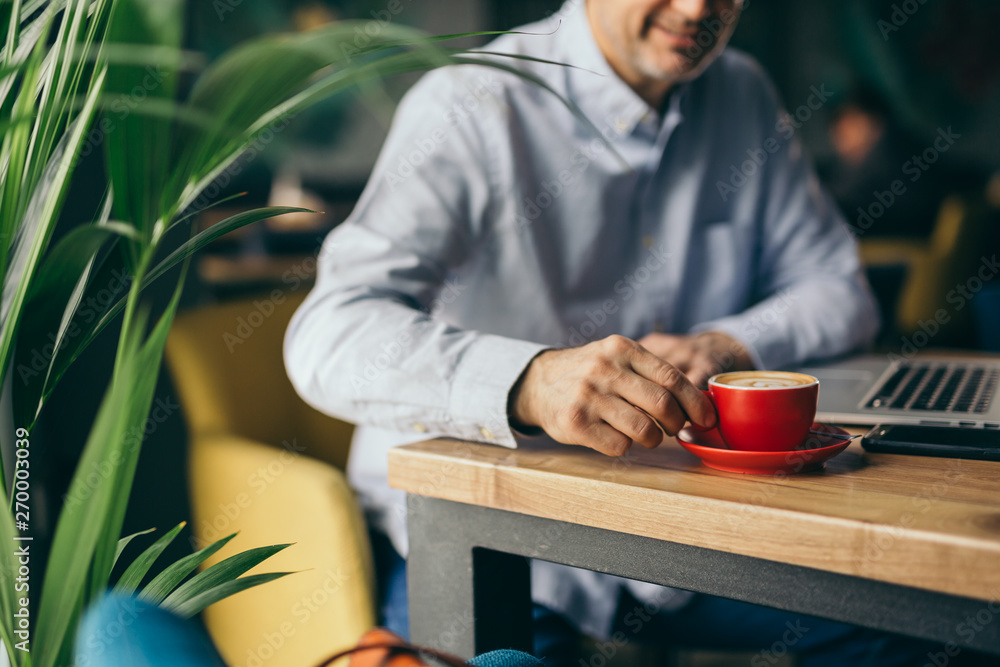 closeup of man drinking coffee in cafeteria closeup of man drinking coffee in cafeteria