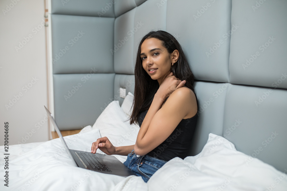 Young pretty woman using laptop in bed Young pretty woman using laptop in bed