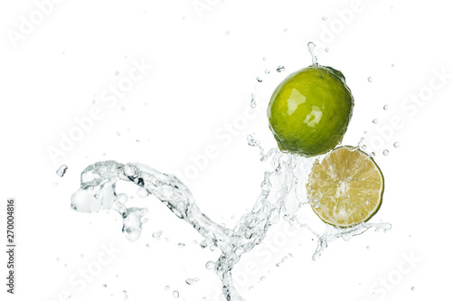 green fresh limes with clear water splash and drops isolated on white