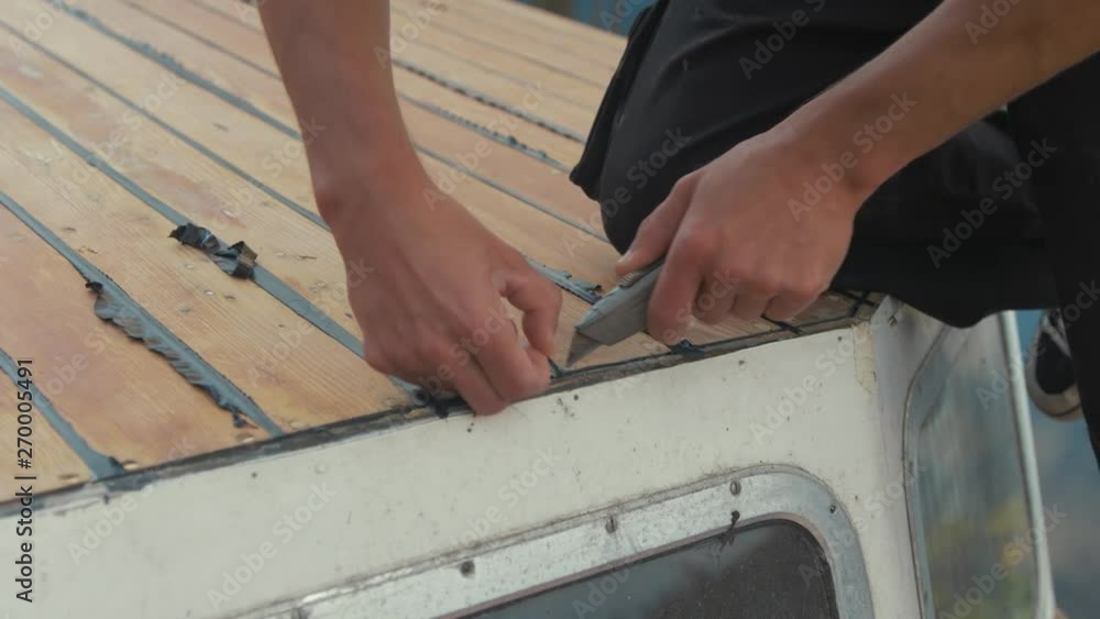 Trimming sika flex mastic flashing sealant at edge of cabin, wooden boat Trimming sika flex mastic flashing sealant at edge of cabin, wooden boat