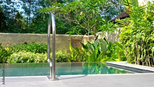 Wallpaper Mural Warm scene in Tropics as breeze blows through poolside plants and trees, no people Torontodigital.ca