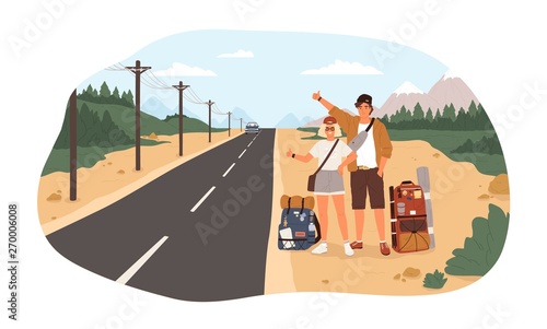 Young happy couple with backpacks standing near road and hitchhiking