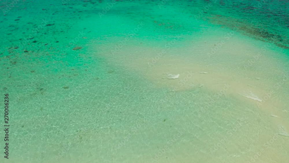 Sea water surface in lagoon with sandy beach and wave, copy space for text, aerial view. Top view transparent turquoise ocean water surface. background texture Sea water surface in lagoon with sandy beach and wave, copy space for text, aerial view. Top view transparent turquoise ocean water surface. background texture