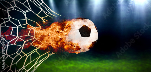 Fototapeta Naklejka Na Ścianę i Meble -  Fiery Soccer Ball In Goal With Net In Flames