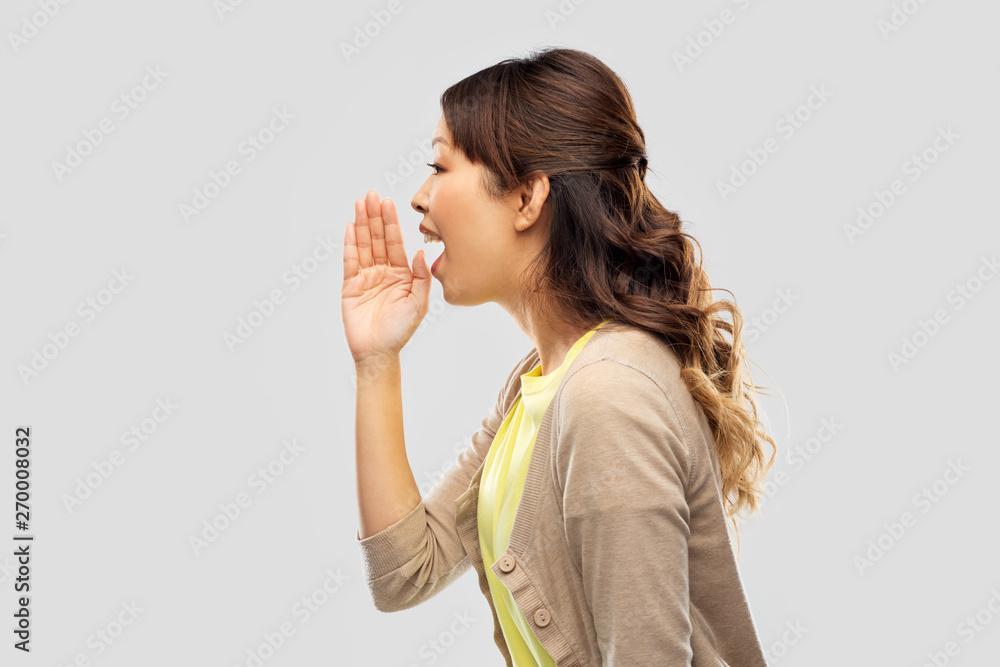 people, information and announcement concept - young asian woman calling for someone over grey background people, information and announcement concept - young asian woman calling for someone over grey background
