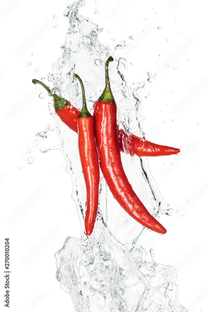 spicy chili peppers with clear water splash and drops isolated on white spicy chili peppers with clear water splash and drops isolated on white