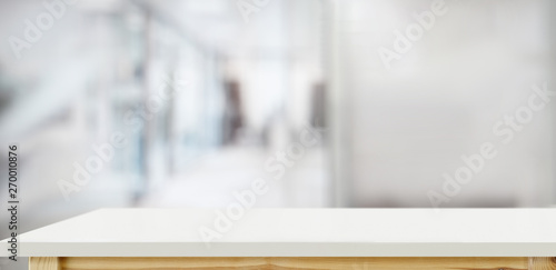White wood top table over office blurred background photo