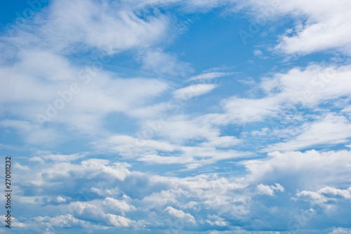 white cumulus clouds in the form of cotton wool on a blue sky. background, bright sky texture