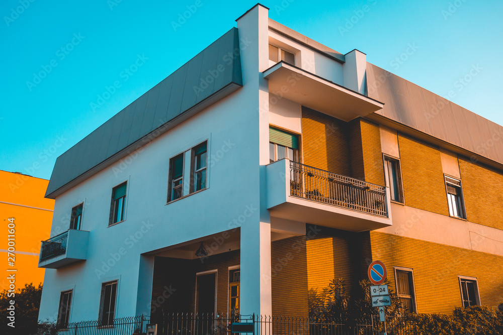 Fototapeta premium modern apartment building with orange and white facade
