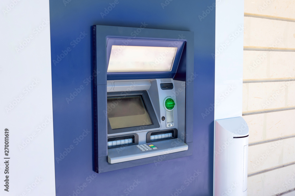 ATM cash machine in the wall of a building on a city street, operating and functional, no people near. ATM cash machine in the wall of a building on a city street, operating and functional, no people near.