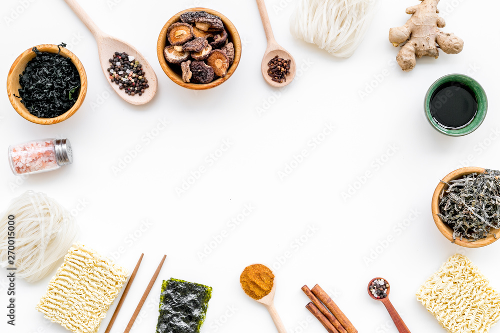Rice vermicelli, noodles, spices, weeds frame to cook Chinese and Japanese food on white background top view copy space