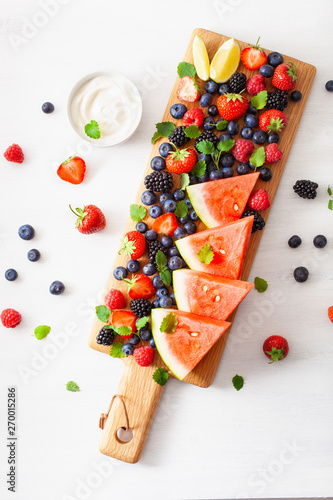 fruit and berry platter over white. blueberry, strawberry, raspberry, blackberry, watermelon