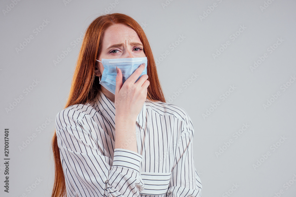 unhappy redhead woman green eyes businesswomen in a striped shirt wearing gauze blue mask white background studio unhappy redhead woman green eyes businesswomen in a striped shirt wearing gauze blue mask white background studio