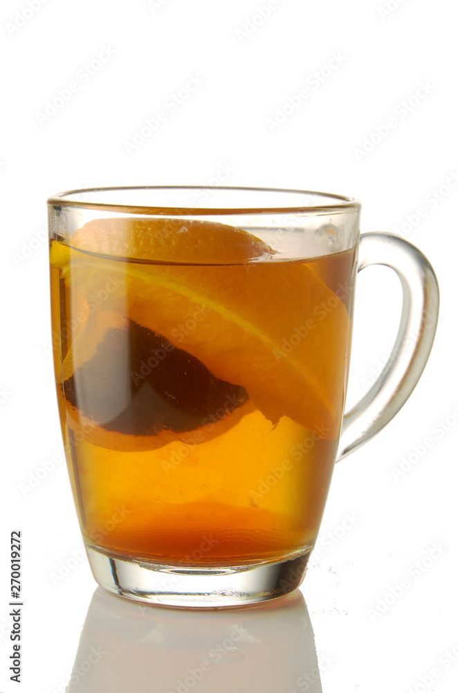 Fresh brewed tea with orange glass mug isolated on white Fresh brewed tea with orange glass mug isolated on white