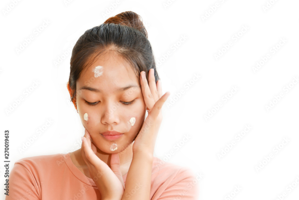 Beautiful Teenage girl Applying cream on the face To treat acne Close up isolated white background Beautiful Teenage girl Applying cream on the face To treat acne Close up isolated white background