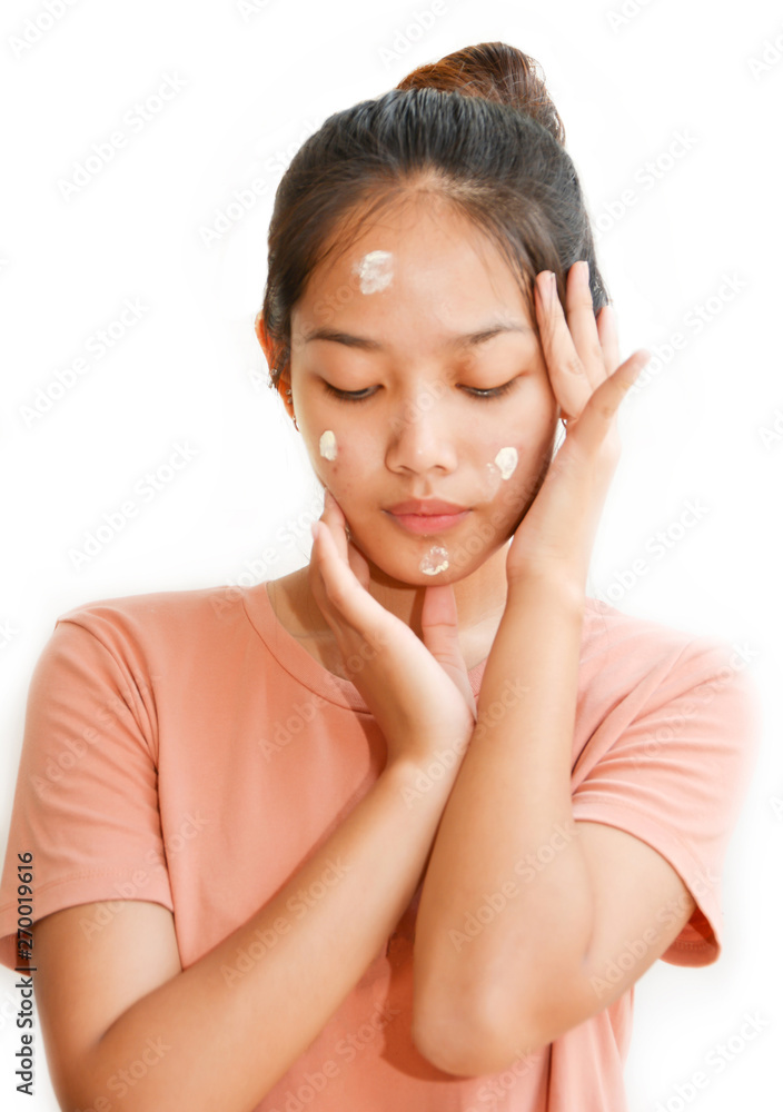 Beautiful Teenage girl Applying cream on the face To treat acne isolated white background Beautiful Teenage girl Applying cream on the face To treat acne isolated white background