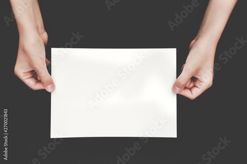 hands holding blank copy space letter on black background