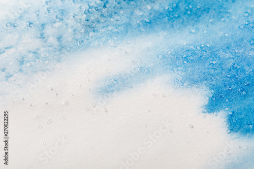 blue colorful watercolor paint spill on white textured background with copy space © LIGHTFIELD STUDIOS