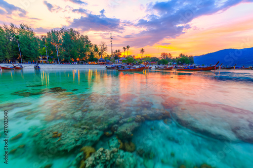 Beautiful sunset on white sand beach and Clear water to see the coral reef at Koh Lipe island in Satun,Thailand photo