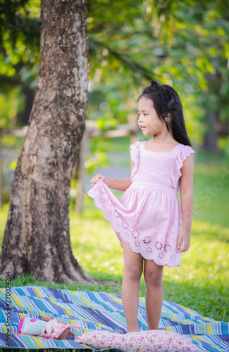 portrait of cute little girl standing in the park