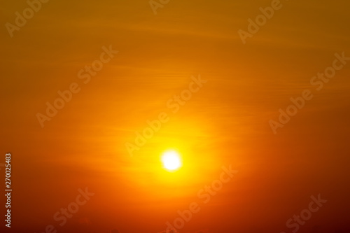 The yellow sun shining on orange sky nature background © c_atta