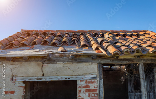 Broken brick on the roof of a cottage