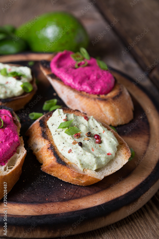Various bruschettas with avocado and beetroot