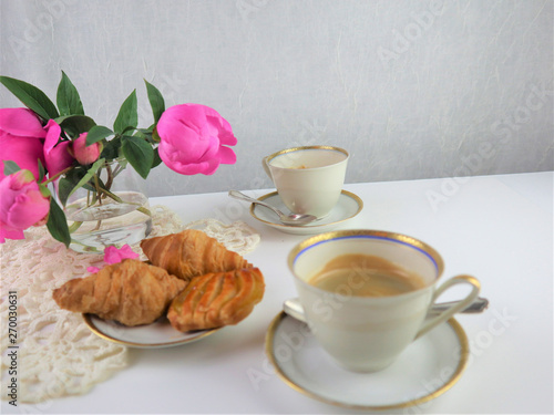 breakfast with two cups of coffee and croissan