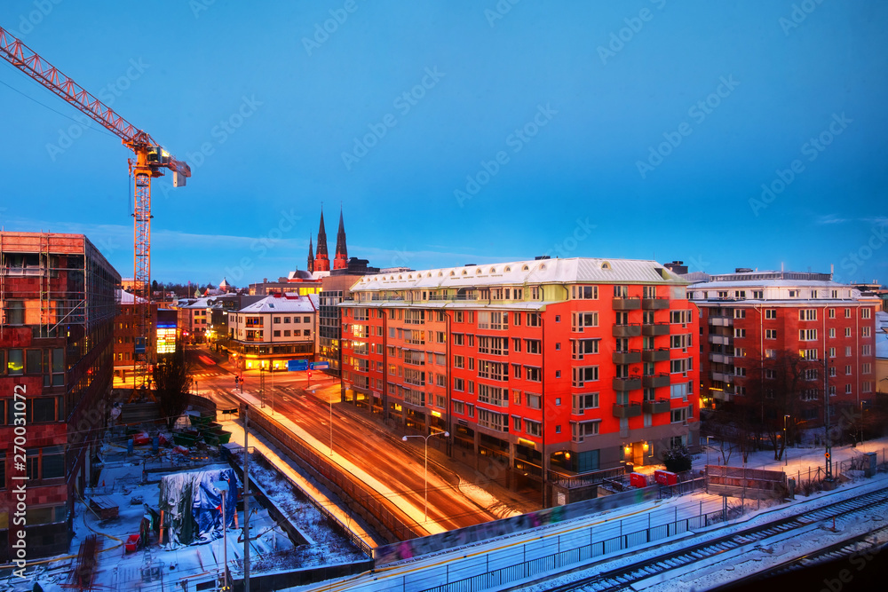 Aerial view of historical buildings in Uppsala, Sweden at sunrise. Night road
