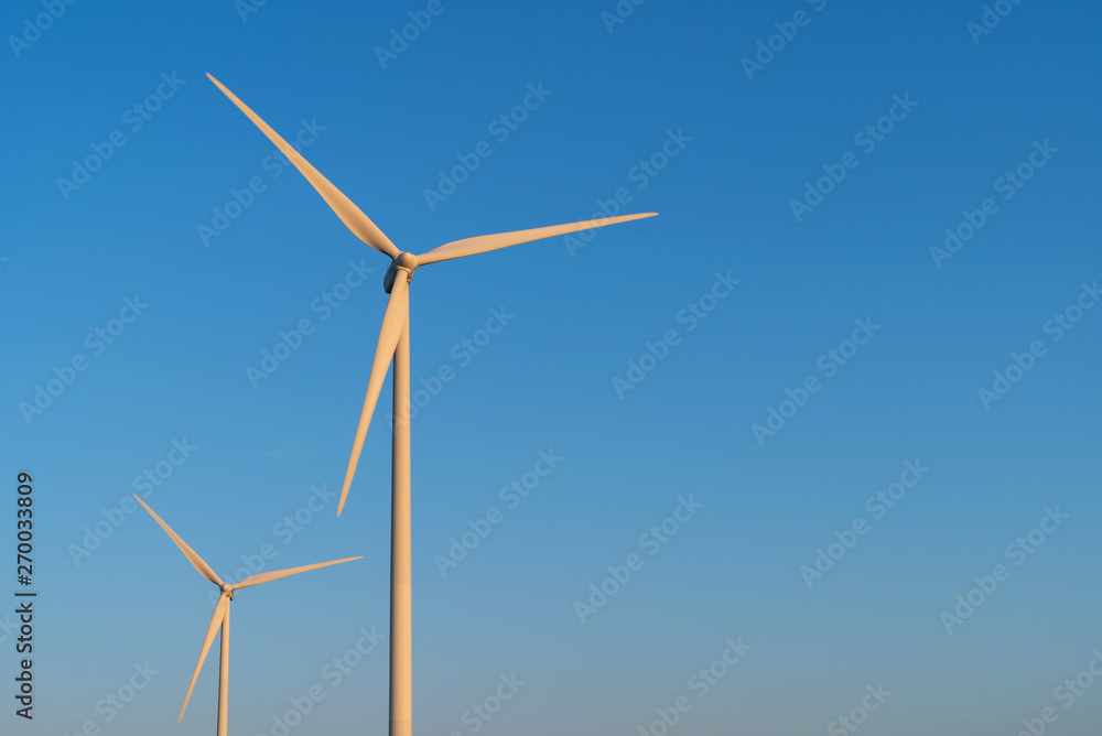 Modern wind turbines generating clean power and a blue sky. Groningen, Holland.