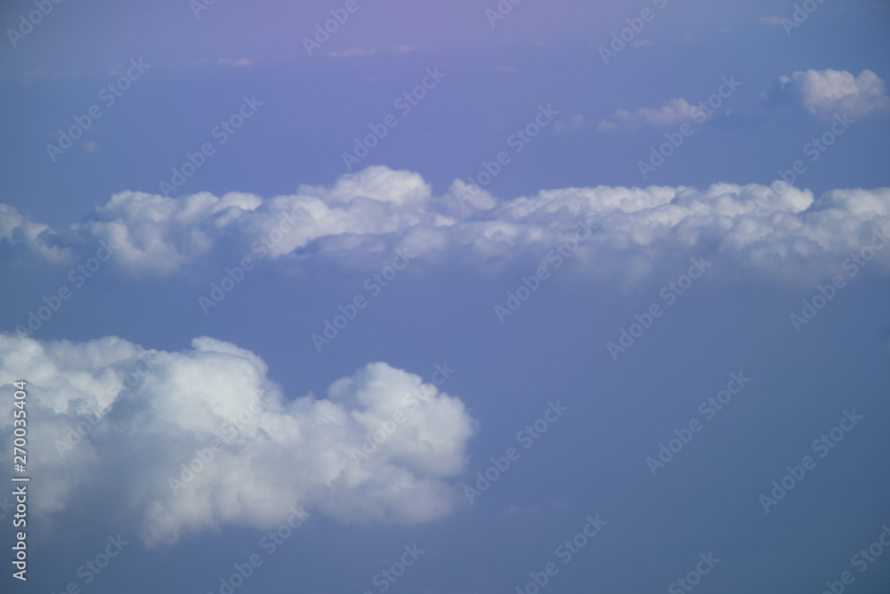 Aerial view from plane window with blue sky and white clouds Aerial view from plane window with blue sky and white clouds