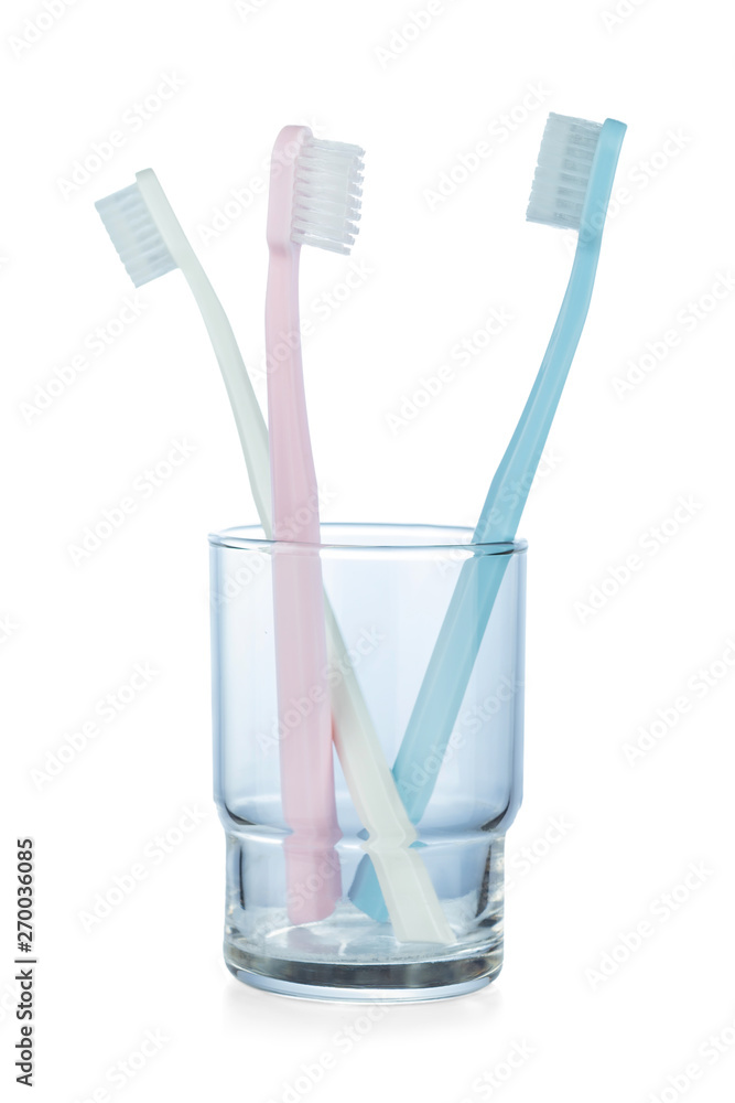 Three toothbrushes in a Cup isolated on white background Three toothbrushes in a Cup isolated on white background