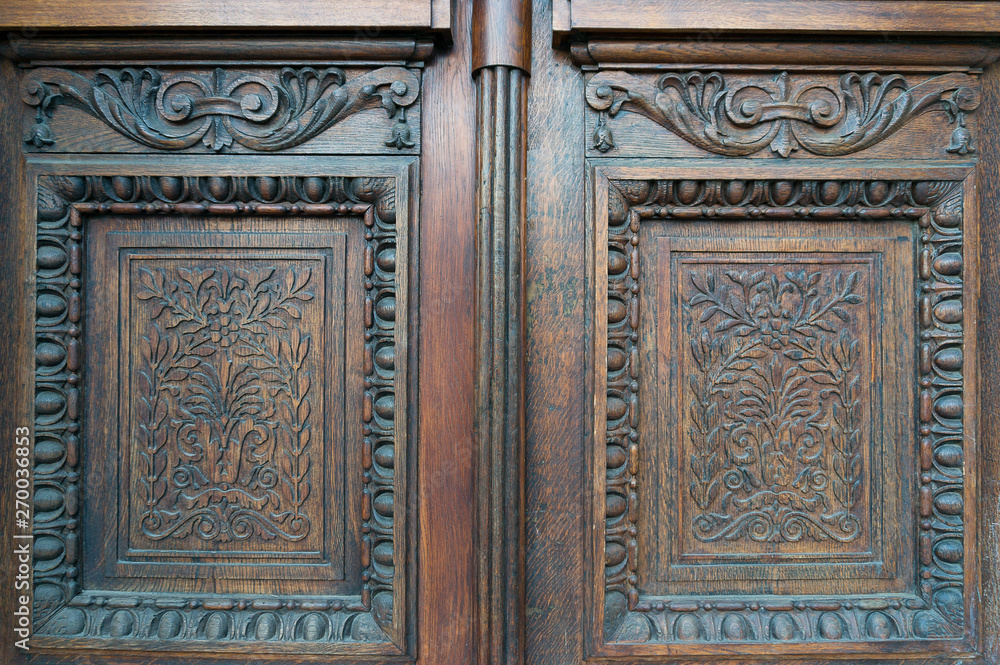 Carved wooden door decoration. Floral motif on door panels