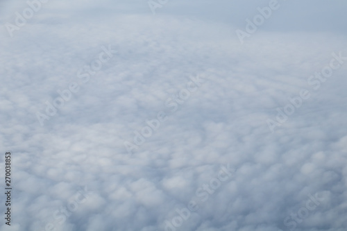 Fototapeta Naklejka Na Ścianę i Meble -  Aerial view from plane window with blue sky and white clouds