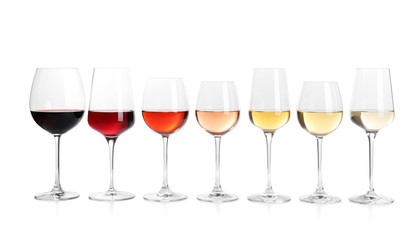 Row of glasses with different wines on white background