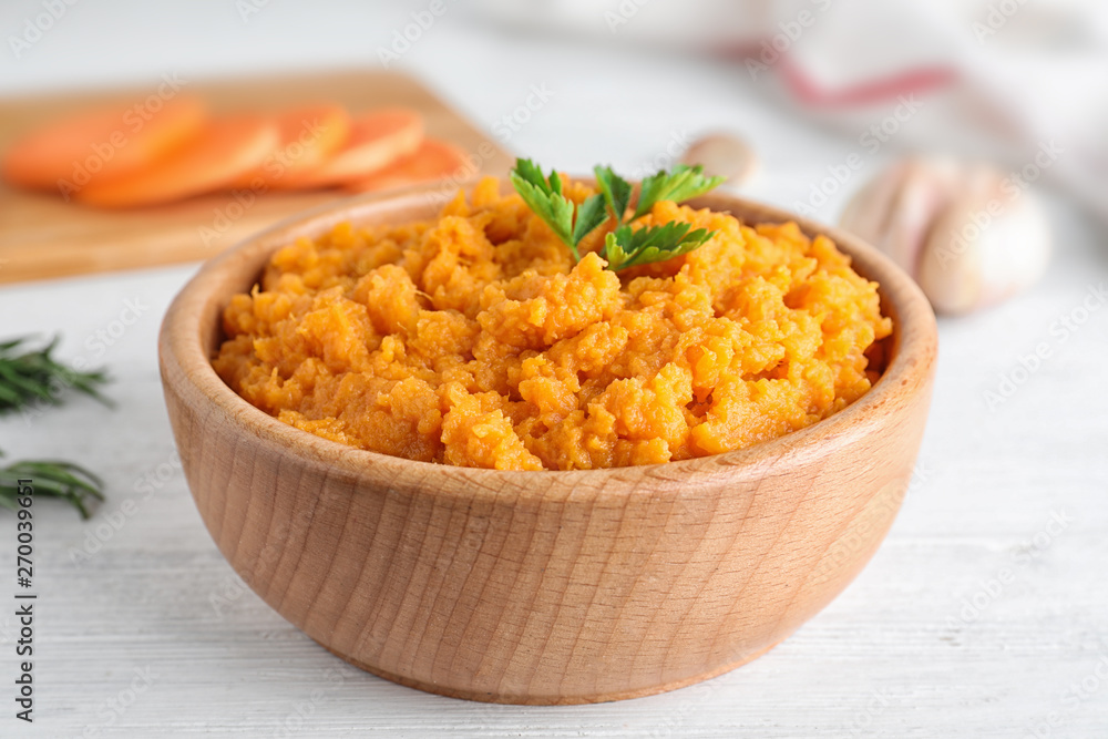Bowl with mashed sweet potatoes on wooden table Bowl with mashed sweet potatoes on wooden table