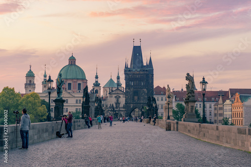 Fotografie, Tablou Charles bridge in Prague at sunrise with photographers and tourists