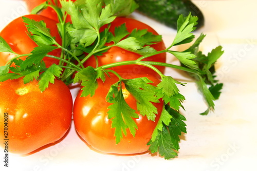 Four red fresh tomatoes healthy and tasty with a bunch of parsley