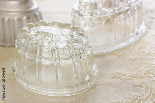 фотографія Old fashioned glass and aluminum jelly or blancmange moulds for making tradition