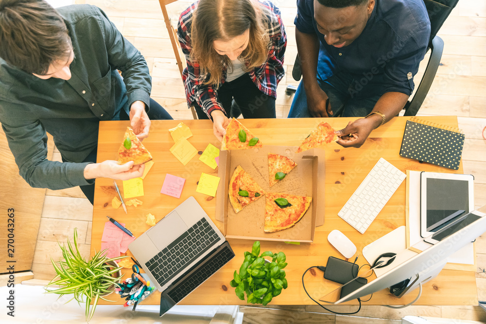 Happy employee people sharing pizza at startup office Happy employee people sharing pizza at startup office