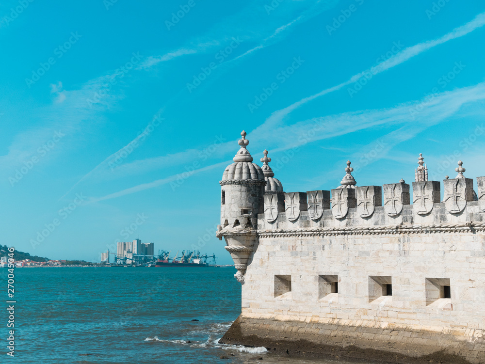 view of the tower of Belem, Tagus river, clear day and blue sky, Lisbon