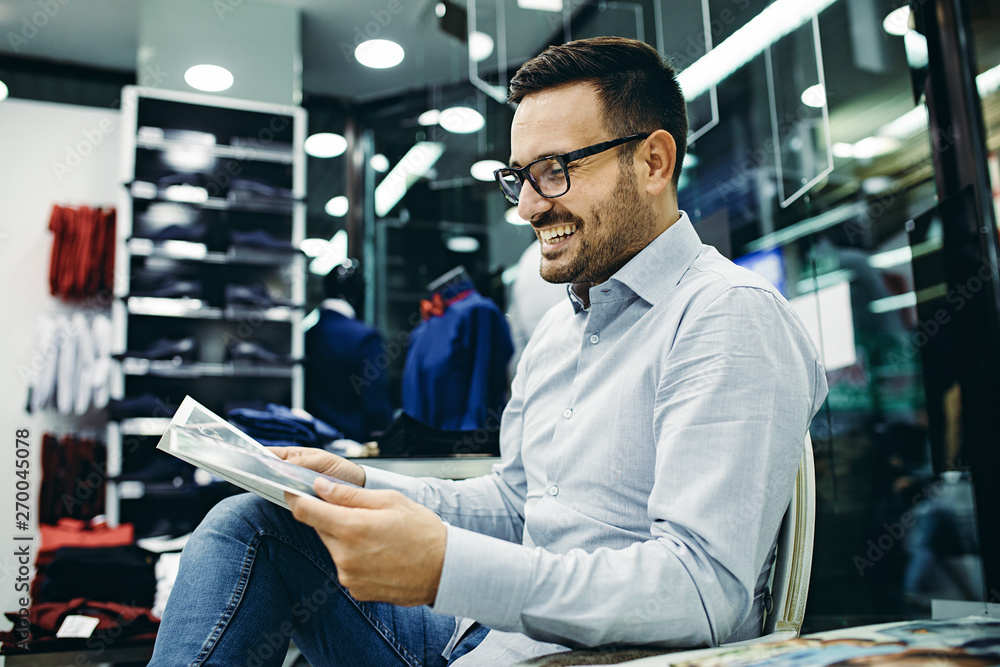 Smiling Young Man Enjoying Shopping Smiling Young Man Enjoying Shopping