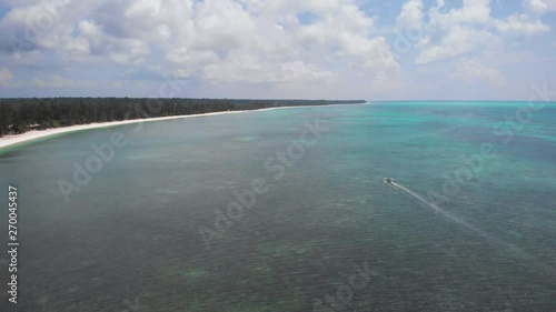 View of a wooden boat in the bay of an exotic island in Balabac, drone shot in Palawan, Philippines photo