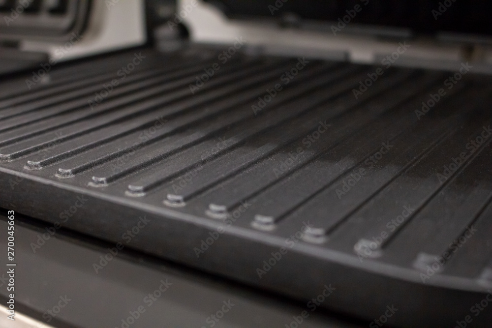 A closeup shot of a panini grill featuring the common grill pattern surface