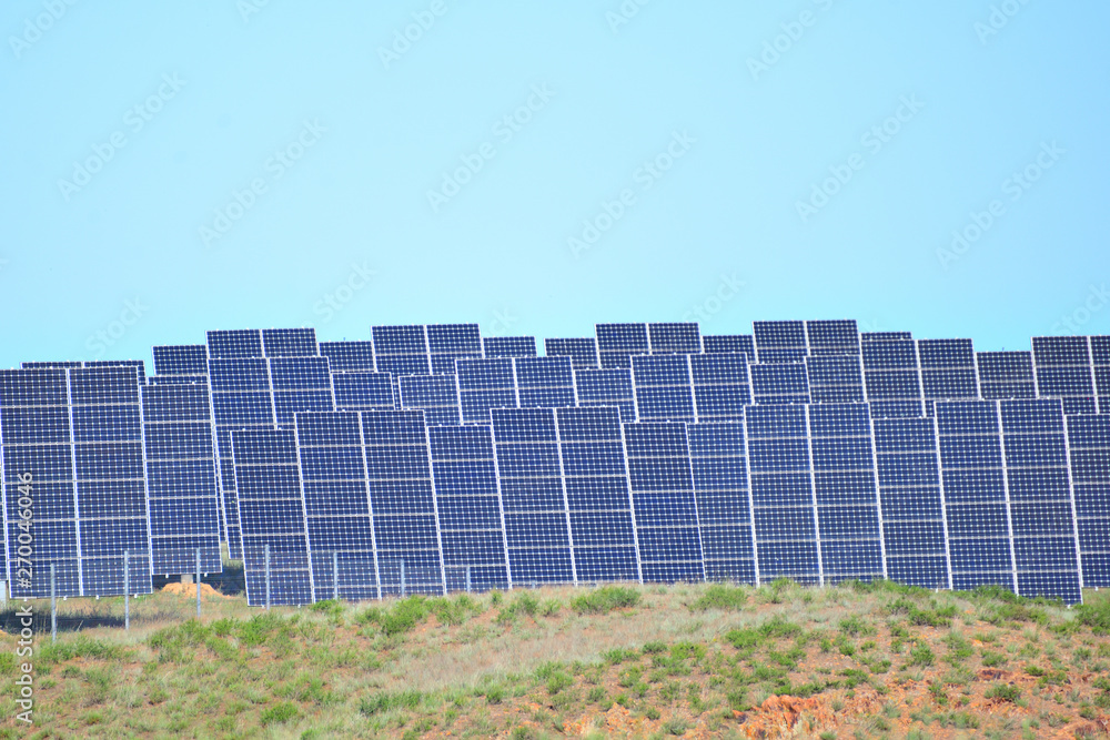 Solar power station in arid area under clear blue sky Solar power station in arid area under clear blue sky