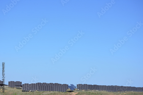 Solar power station in arid area under clear blue sky
